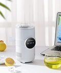 Sharp Two In One Electric Cooling Cup And Slim Desktop Beverage Chiller beside a laptop, cooling drinks with a sleek design.