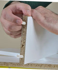 Hands installing 100 Piece Stainless Steel Cylindrical Dowel Pins For Machinery Automotive And Electronics on wood panel.