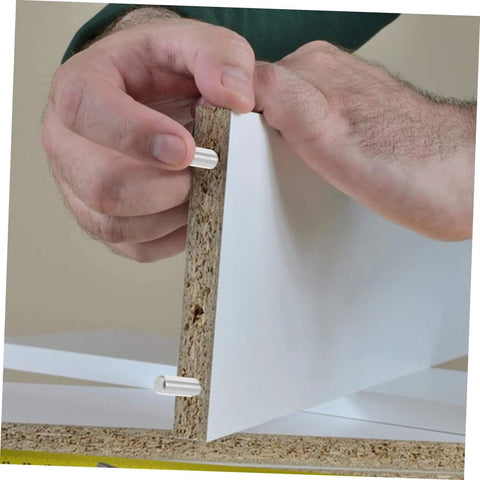 Hands installing 100 Piece Stainless Steel Cylindrical Dowel Pins For Machinery Automotive And Electronics on wood panel.