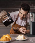 Heavy Duty Fully Automatic Espresso And Drip Coffee Maker With Digital Display Six Steam Nozzles For Killer Brews pouring coffee into a cup.