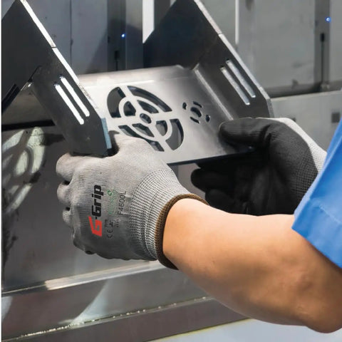 Hands wearing F4600 G Grip Micro Foam Nitrile Palm Coated Seamless Work Gloves With 15 Gauge Nylon Shell handling metal panel.