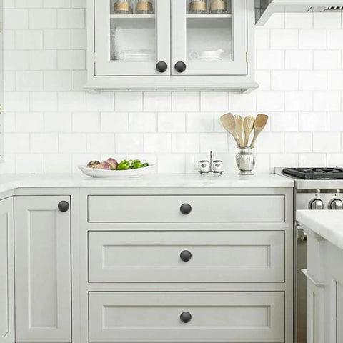 Matte Black Zinc Cabinet Knob And Drawer Pull Set installed in a modern kitchen, showcasing smooth finish and Euro style.