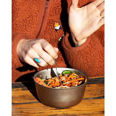 Person using Titanium Trek Camping Bowl Ultralight And Durable For Hiking And Backpacking Stackable Outdoor Kitchen Essential