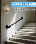 Heavy Duty Industrial Pipe Stair Handrail Black Wall Mount Safety Grab Bar For Indoor Outdoor Steps With Full Mounting Kit installed on stairway wall.