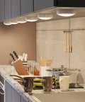 Under-cabinet view of Color Changing LED Puck Lights With Remote, 6 Pack Stick On Battery Powered Under Cabinet Lighting
