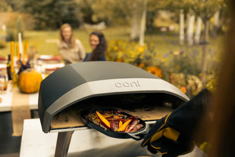 Koda 16 Inch Propane Gas Pizza Oven with 28 MBAR Regulator and Hose Outdoor Portable Oven in use, baking pizza outdoors.