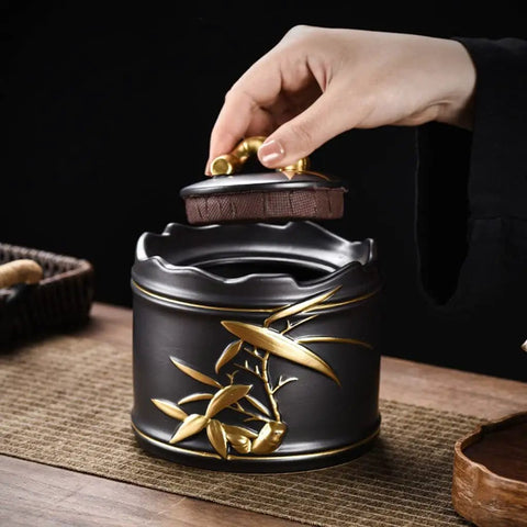 Hand lifting the lid of a Heavy Duty Ceramic Coffee Canister With Locking Airtight Lid on a wooden table.