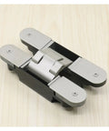 Concealed Secret Door Hinge For Thick Doors Stealthy Hidden Pivot Hardware in sleek metal finish on light wood surface