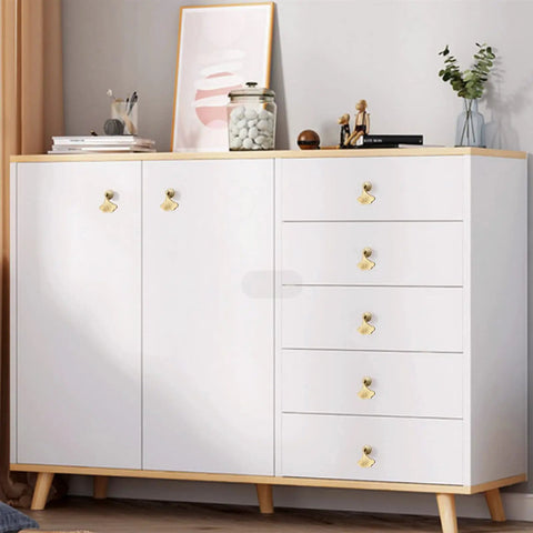 Six Piece Golden Ginkgo Leaf Cabinet Knobs on a sleek white cabinet with wooden accents, perfect for drawers and wardrobes.