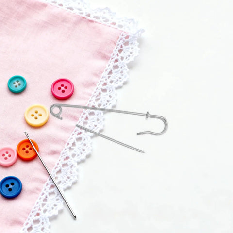 Heavy Duty Safety Pins Set For Clothes And Shawls, Iron Fabric Clips With Strong Grip on pink fabric with buttons.
