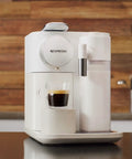 One Touch Automatic Milk Coffee Brewer With Integrated Frother For Barista Level Espresso And Smooth Morning Kick Premium White Finish on countertop with coffee.