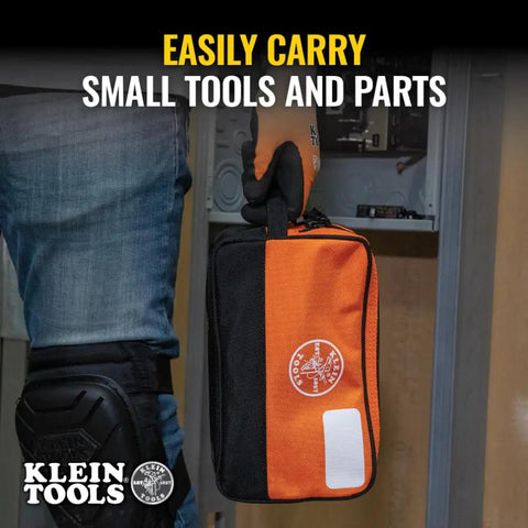Person holding Heavy Duty Tool Pouch With Dual Compartments For Quick Organization Of Meters Leads Sockets Wrenches And Small Parts In A Tough As Nails Multipurpose Tool Bag You Can Count On, featuring black and orange design with visible logo.