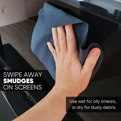 Microfiber lens screen cleaning cloth, blue-gray suede, being used to wipe a screen (close-up)