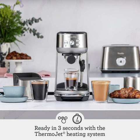 Compact Espresso Machine With 54mm Portafilter And 19 Gram Dose Auto Steam Wand For Milky Microfoam Barista Vibes Third Wave Pro Grade Coffee At Home Brushed Stainless Steel Finish Easy One Touch Espresso And Milk Texturing on kitchen counter with cups