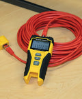 Close-up of RJ45 Cable Tester Kit With LAN Scout Jr 2 next to a red cable on a table