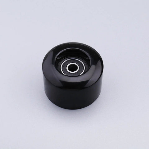 Close-up view of a single black wheel from a 4 Pack 54mm Quad Roller Skate Wheels 80A Hardness With ABEC Nine Bearings on gray background