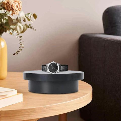 Cool Electric Turntable Display That Spins Your Goods 360 For Amazing Trade Fairs And Photo Shoots Plus It Runs On USB To Keep Things Easy And Green on a wooden table with a black watch.