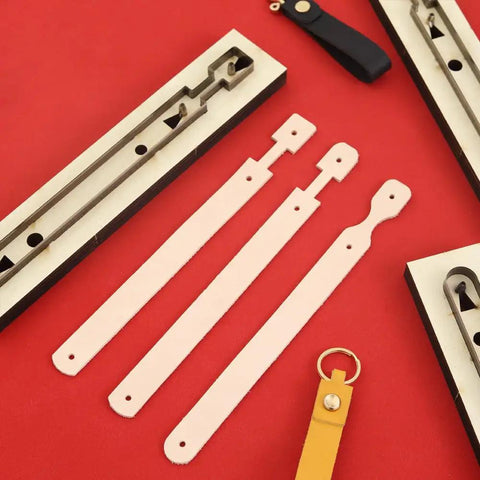 Three Piece Long Keychain Cutting Mold Set With Dog Paw Pattern Punch Tool For DIY Leathercraft, visible steel stencil and wooden base.