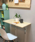Heavy Duty Stainless Steel Floating Shelf Brackets Two Pack Straight Up Rock Solid Triangle Wall Mounts Built Tough Rust Resistant Support Beams Perfect For Kitchen Cabinets And Living Spaces Game Changer used to support a small wooden table with plants.