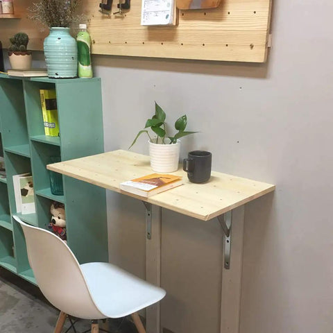 Heavy Duty Stainless Steel Floating Shelf Brackets Two Pack Straight Up Rock Solid Triangle Wall Mounts Built Tough Rust Resistant Support Beams Perfect For Kitchen Cabinets And Living Spaces Game Changer used to support a small wooden table with plants.