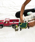 Child playing with 38 Piece Trailer And Truck Transporter Playset With Realistic Horse And Rider Figures Saddle Bridle Hay Bales And Accessories