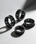 Close-up of 305 Piece Black Nylon Cable Snap Grommets Set Round Locking Bushing Protectors For Wires on gray background