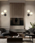Two Light Globe Wall Sconce With Frosted Glass Globes lighting in modern living room with dark chairs and table