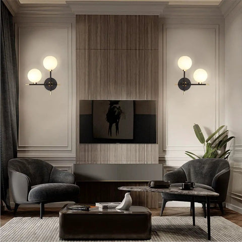Two Light Globe Wall Sconce With Frosted Glass Globes lighting in modern living room with dark chairs and table