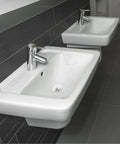 Universal Bathtub Drain Stopper, Stainless Steel Silicone, 42-44mm installed in modern bathroom sinks with chrome faucets.