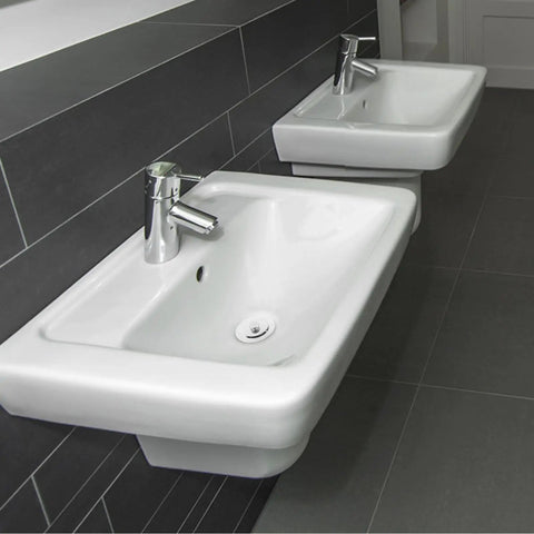 Universal Bathtub Drain Stopper, Stainless Steel Silicone, 42-44mm installed in modern bathroom sinks with chrome faucets.
