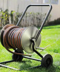 Heavy Duty Metal Hose Reel Cart, Built Like A Tank Outdoor Garden Drum with stainless steel drum and wheels on grass.