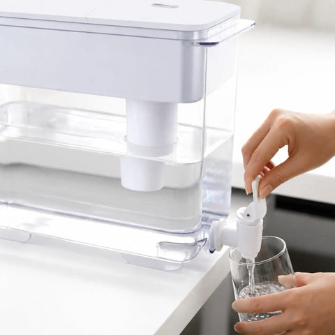 9L Water Dispenser System For Home Or Office, 40 Cup Countertop Hydration Station pouring water into a glass