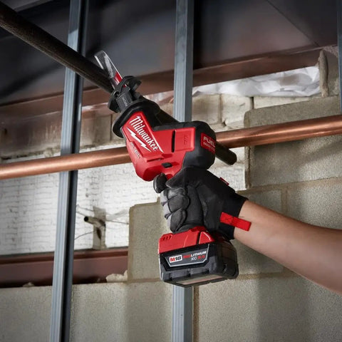 M18 Fuel One Handed Reciprocating Saw Kit cutting copper pipe, detailed view of grip and battery for home renovation projects.
