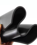 Heavy Duty Black Rubber Anti Vibration Mat For Machinery Oil Proof Shop Grade Shock Absorber Pad in hand, showcasing texture and flexibility.