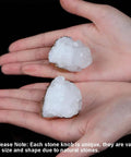 Four Pack Beefy Natural Quartz Geode Cabinet Knobs Combined With Slick Druzy Crystal Drawer Handles Featuring Clean Gold Plated Edges And Heavy Duty Stone Pulls For Kitchen Vanity Refresh, two unique quartz knobs held in hands.