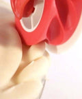 Close-up view of a red handheld pastry wheel with a white guard for lattice pie crust.
