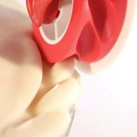 Close-up view of a red handheld pastry wheel with a white guard for lattice pie crust.