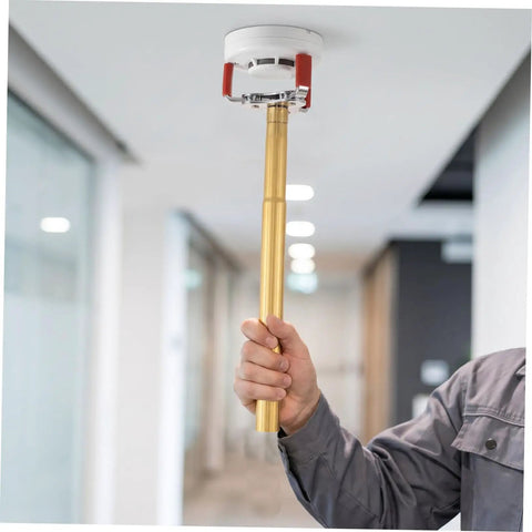 Slick Aluminum Alloy Ceiling Smoke Detector Puller With Heavy Duty Claw Head lifting smoke detector with a golden aluminum pole.
