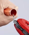 Close-up of TubiX Pipe Cutter With Quick Adjustment One Hand No Fuss Quick Lock cutting a copper pipe held by a hand.