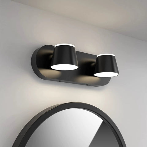 Wall-mounted matte black LED bathroom vanity light over round mirror showing modern sleek design.