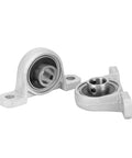 Two KP001 flange-mounted pillow block bearings with 12 mm bore, zinc alloy housing.