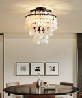 Capiz Shell Semi Flush Mount Ceiling Light in Matte Black for Bedroom and Kitchen Dope Coastal Style Pendant Fixture With Hundreds of Capiz Shells Elegant Romantic Ocean Vibe for Hallway and Entry, viewed in a dining room setting.