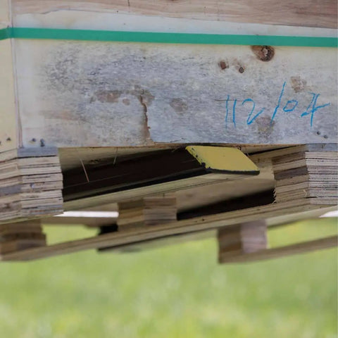 Light Duty Clamp On Pallet Forks, 43 Inch Overall Length under wooden pallet, showcasing 30 Inch By 3 Inch Fork Blades in use