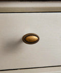 Close-up of antique brass drawer pull from 10 Pack Antique Brass Cabinet Knobs And Vintage Drawer Pulls For Kitchen Cabinets Dressers And Cupboards