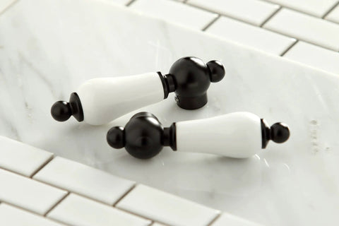 White and black decorative chess-like knobs on a tiled surface