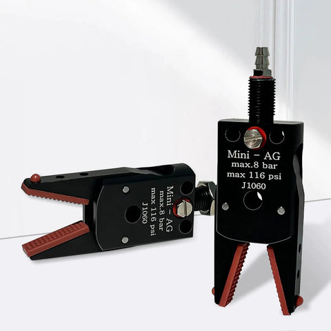 Mini Pneumatic Parallel Gripper J1060 with extended jaw, black and red design, for precise pick and place, shown in dual positions.
