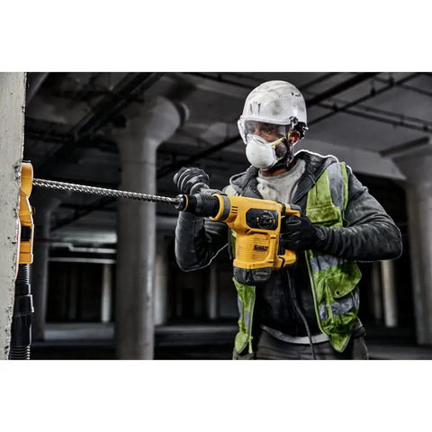 Worker using Pro Grade SDS Max Rotary Hammer Drill Bit 1 Inch By 31 Inch By 36 Inch With 4 Cutter Head on concrete wall