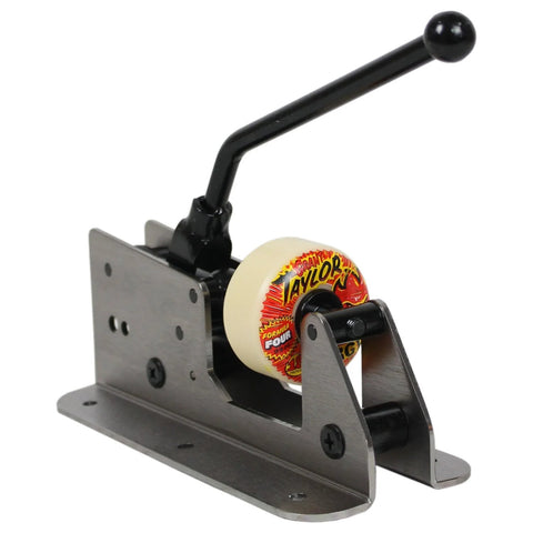 Front view of Amphetamine bearing press and puller for skate wheels; metal base, black L-shaped lever, Taylor-branded roller wheel.