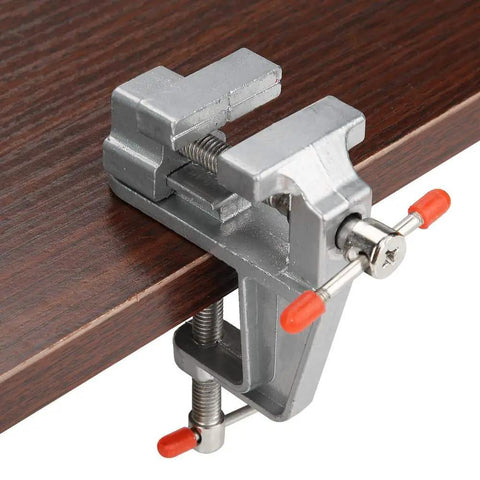 Rock Solid Mini Flat Pliers Bench Vise And Tabletop Clamp For Precision Woodwork Drill Press Vice shown clamped to wooden surface.