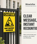 Heavy Equipment In Operation Aluminum Warning Sign 12x8 Inches Durable Construction Site Safety Sign With High Visibility Yellow And Black Bold Caution Graphic Pre Drilled Holes For Easy Mounting mounted on a black fence next to building